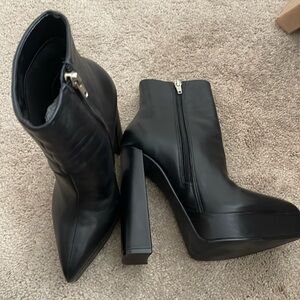 5 1/2 inch heel platform ankle boots in black. Perfect condition.
